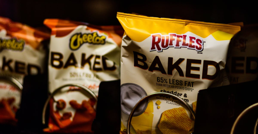 Close-up of a vending machine showcasing baked snacks like chips for a tasty treat.